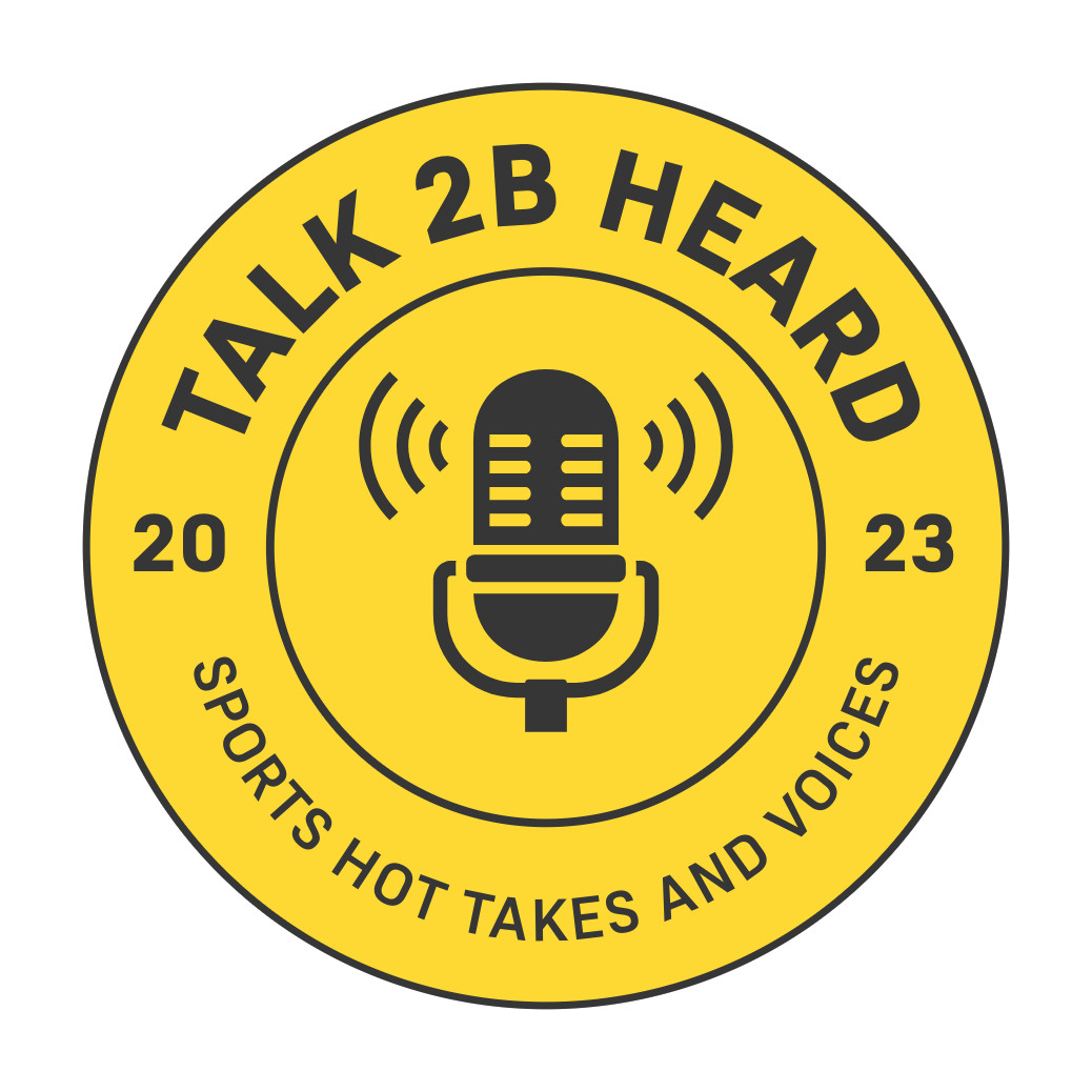 The Talk 2B Heard emblem: a yellow badge ringed with the wordmark, the year 2023 and the line Sports Hot Takes and Voices, around a microphone